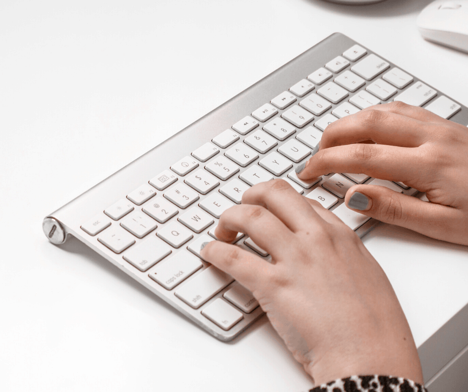 Typing hands on a keyboard narrowing a blog niche